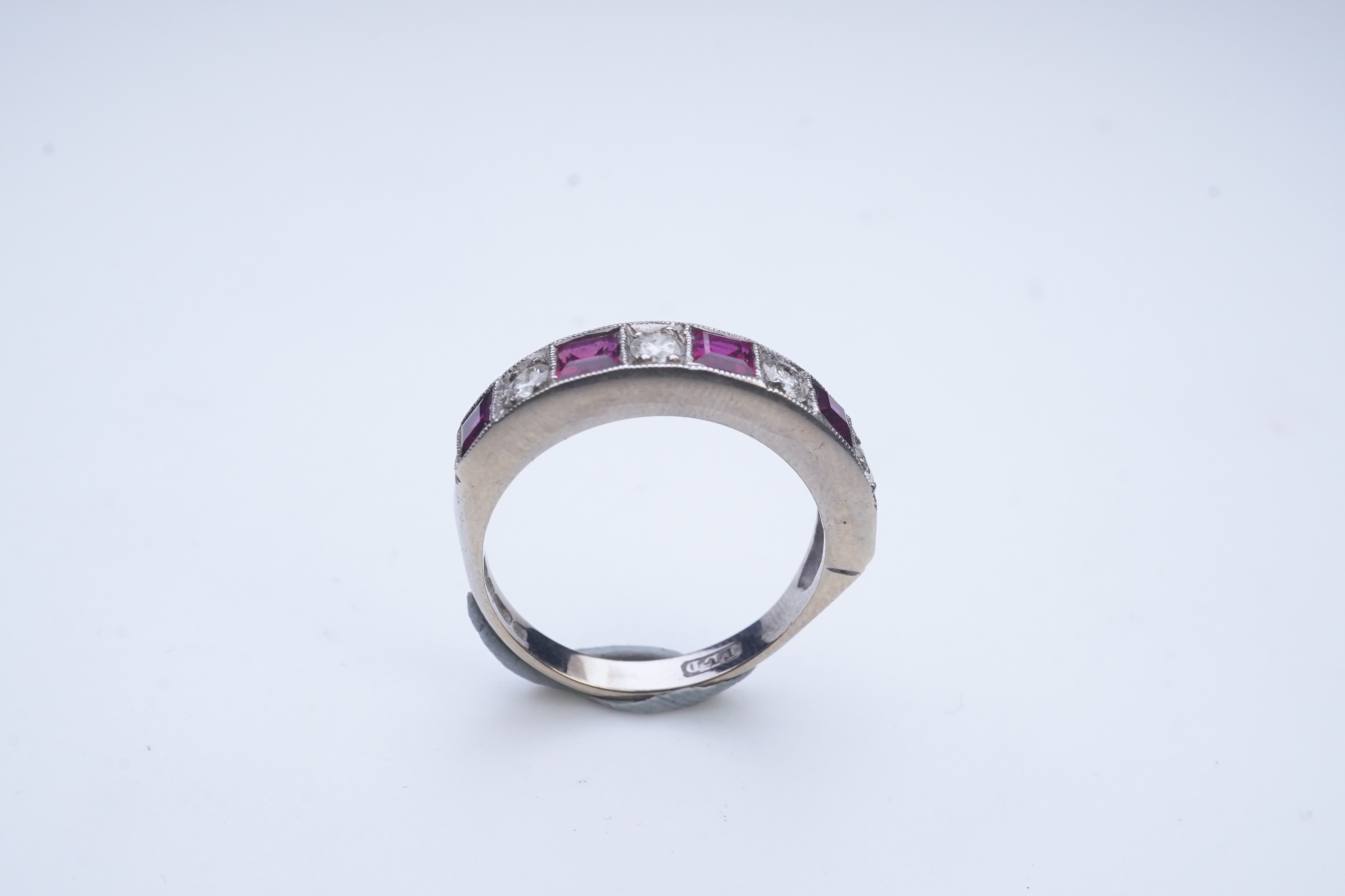 A ruby and diamond half eternity ring